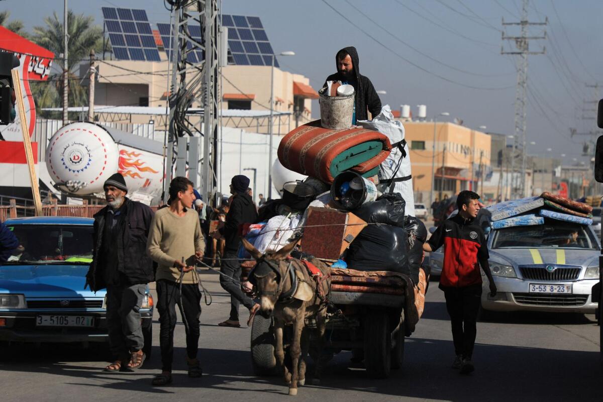Palestinians transport belongings on an animal-drawn cart, as they flee their houses after they were ordered by the Israeli army to evacuate the area in Bureij, central Gaza Strip, on December 26. — Photo: Reuters