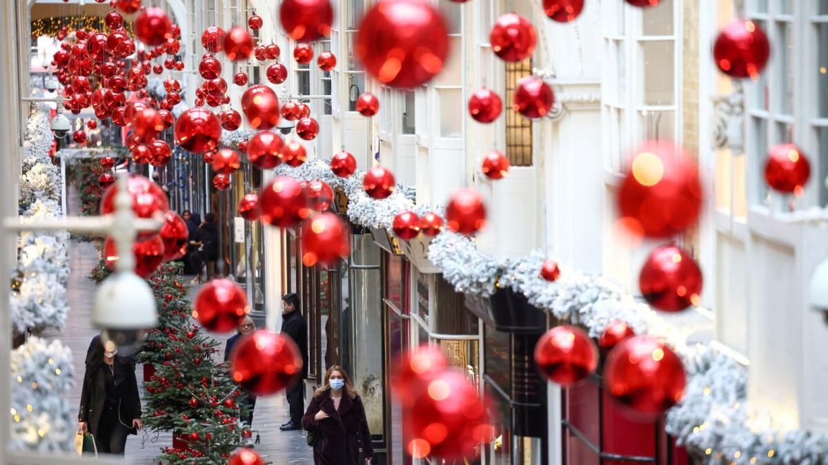 People walk through the Burlington Arcade adorned with Christmas decorations, amid the coronavirus disease (COVID-19) outbreak, in London, Britain, November 23, 2020.