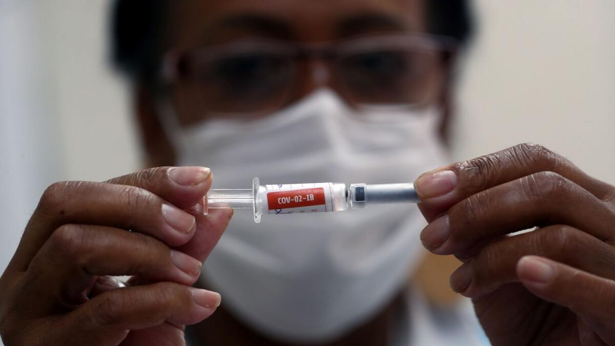 A nurse holds a syringe before administering an injection to a volunteer in the trial stage of the Coronavac, SinoVac's coronavirus disease (COVID-19) vaccine, at Emilio Ribas Institute in Sao Paulo, Brazil December 11, 2020.