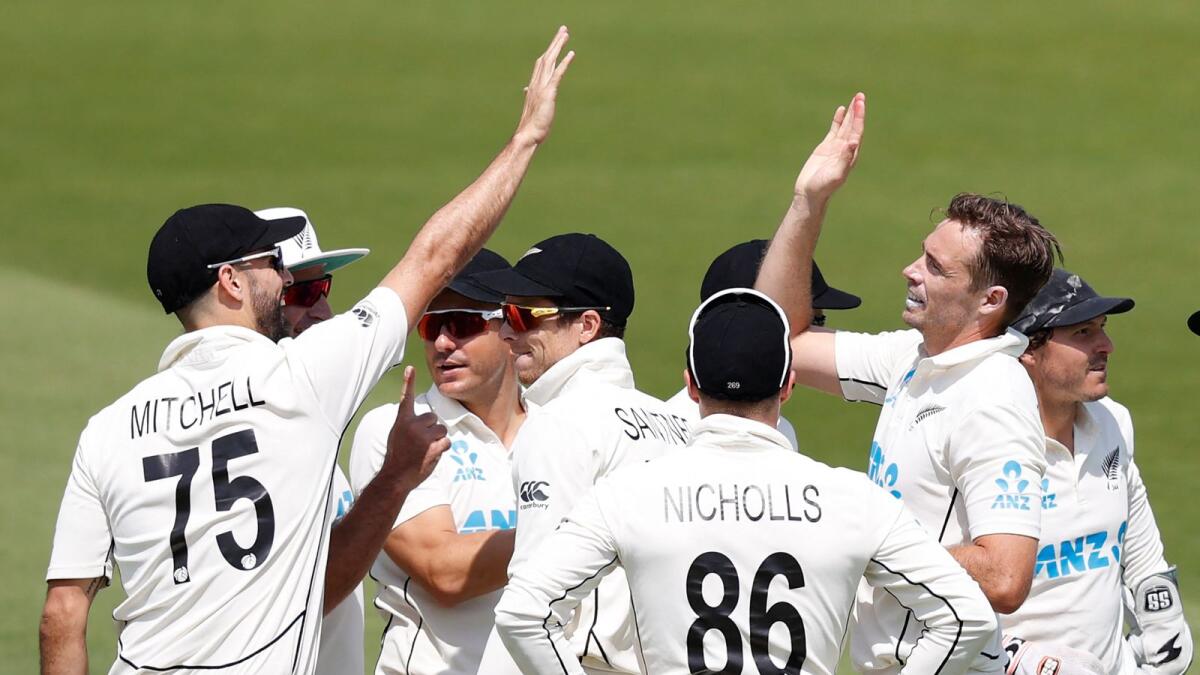 New Zealand's Tim Southee (right) celebrates with teammates after taking the wicket of England's James Bracey . — AFP