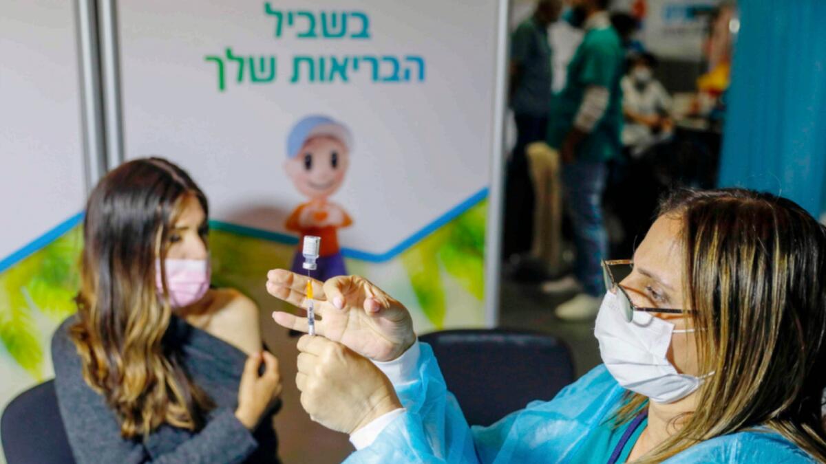 A healthcare worker prepares a dose of the Cvid-19 vaccine at the Kupat Holim Clalit clinic in Jerusalem. — AFP
