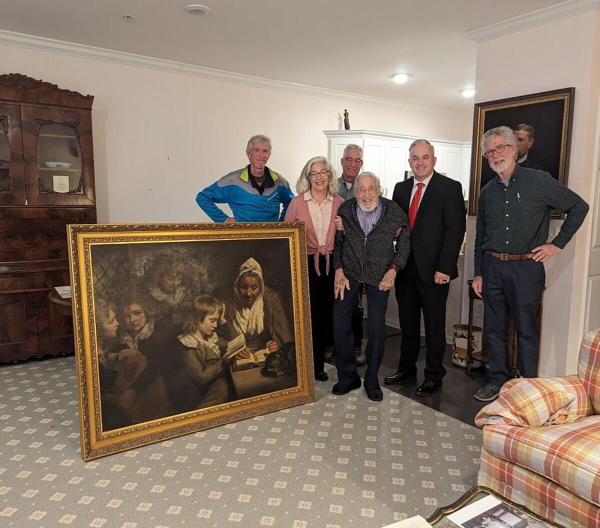 Special Agent Gary France, second right, Dr Francis Wood and Wood’s children stand next to the John Opie painting that was stolen from Wood’s parents' home in 1969 in Newark, New Jersey, on January 11, 2024. — AP