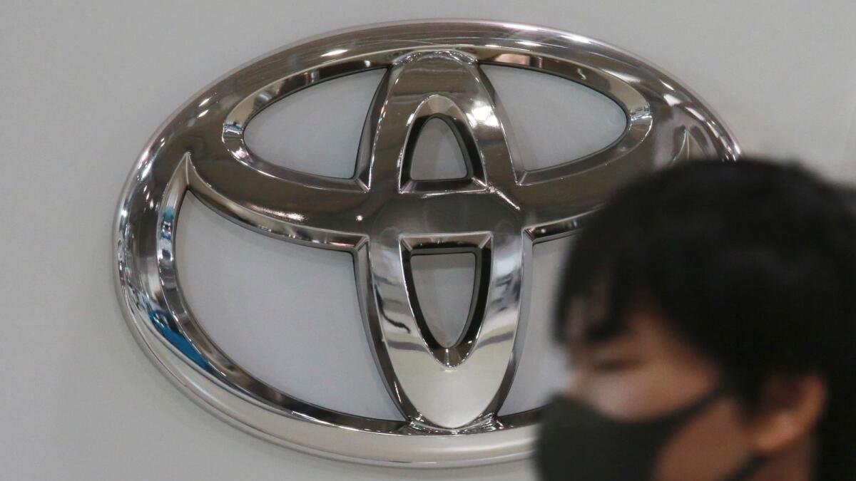 A visitor walks by a Toyota showroom in Tokyo. — AP file photo