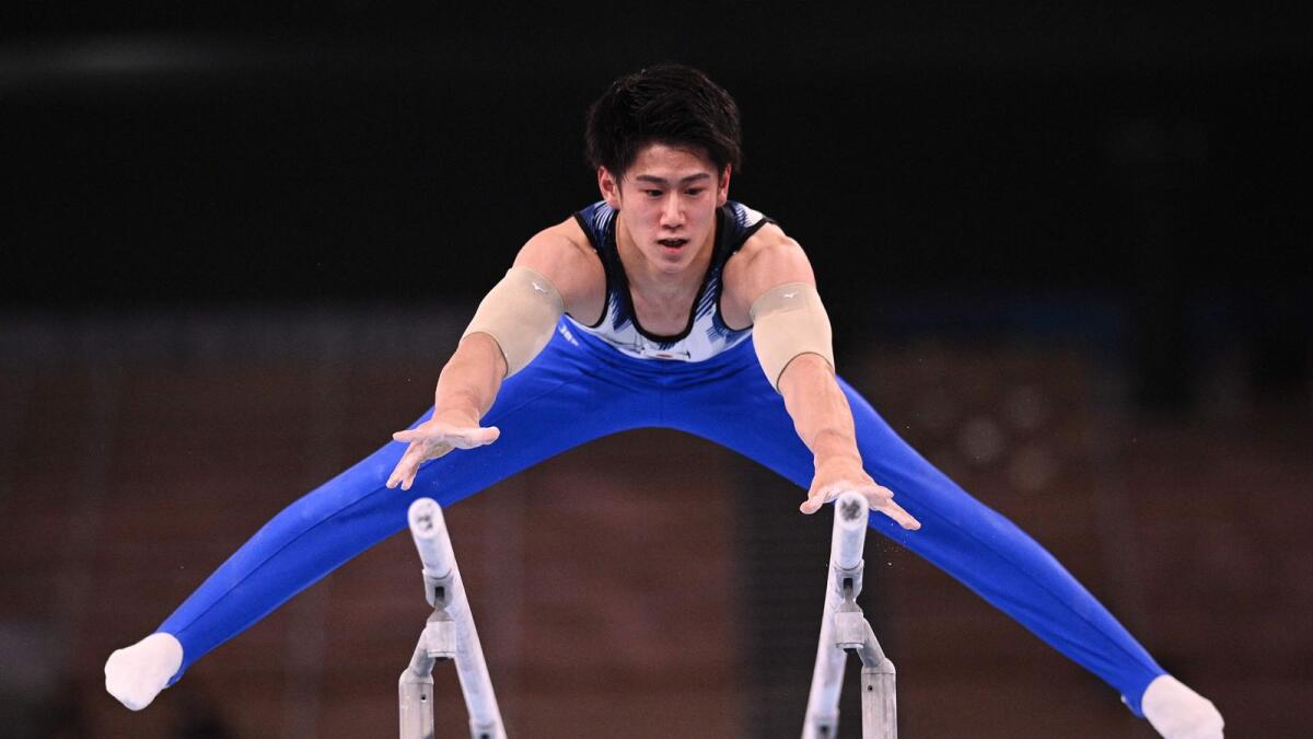 Japan's Daiki Hashimoto competes in the parallel bars event of the artistic gymnastics men's all-around final. (AFP)