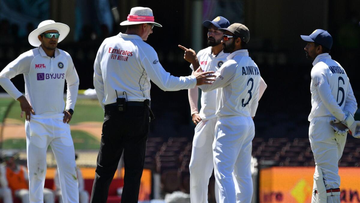 India's captain Ajinkya Rahane speaks to umpire Paul Rieffel as the Sydney Test was briefly halted after more racial abuses were hurled towards Maohammed Siraj (third right) on the fourth day of the Sydney Test. (AFP)