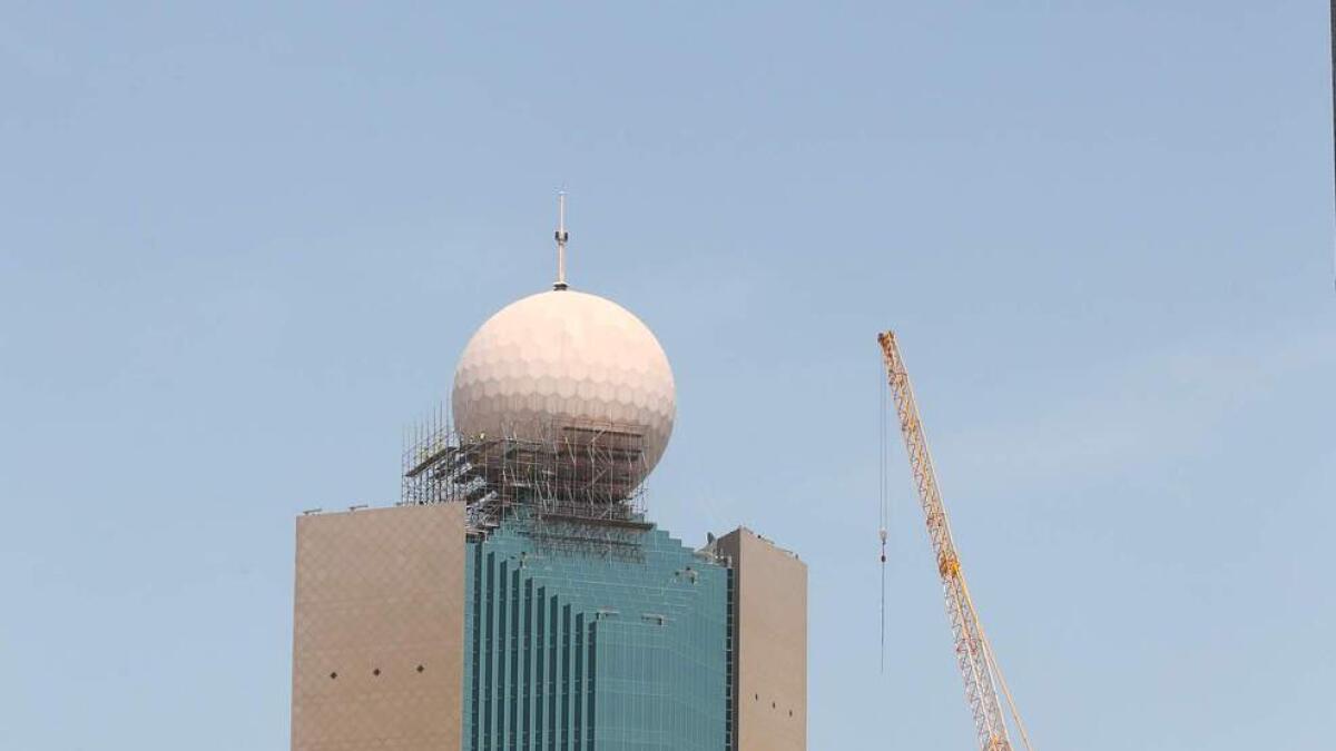 The ‘golf ball’ atop the etisalat headquarters in Abu Dhabi is in the process of being dismantled and100 metres perimetre around the building has been closed to all traffic. — Photo By Ryan Lim