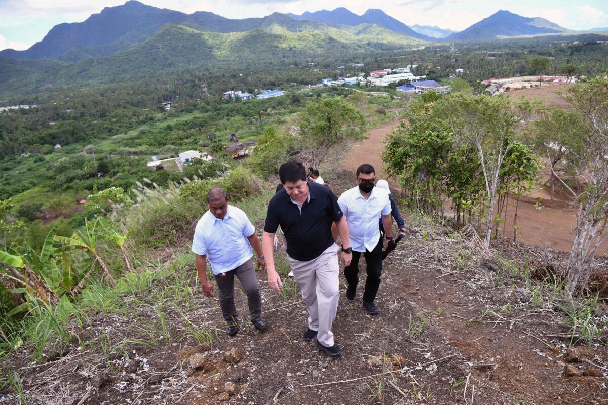 Mayor Alfred Romualdez (C) and other city officials inspecting the site of a proposed memorial park remembering the Super Typhoon Haiyan disaster in the outskirts of Tacloban city, Leyte province. — AFP