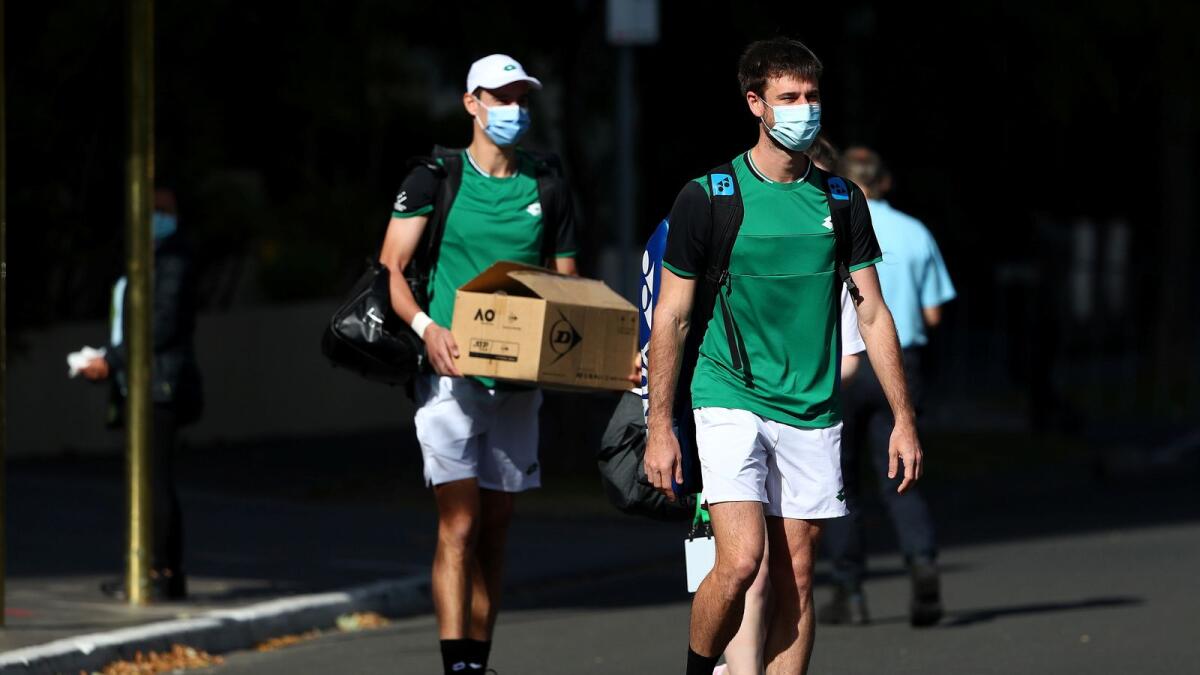 Tennis players are escorted from accommodations where they are undergoing mandatory quarantine to train at a nearby facility in advance of the Australian Open in Melbourne. — Reuters