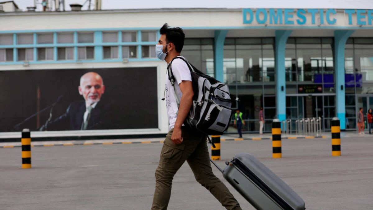 A passenger walks to the departures terminal of Hamid Karzai International Airport. — AP