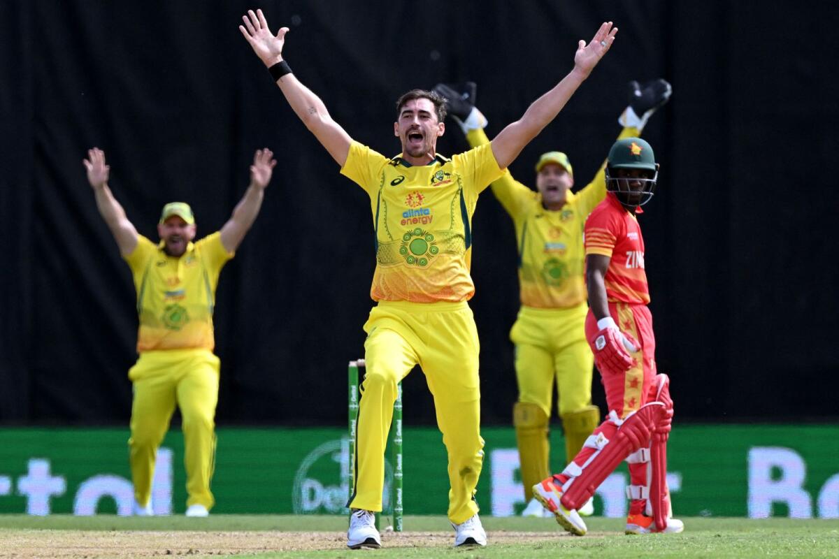 Australia's Mitchell Starc (centre) appeals successfully for an LBW decision against Zimbabwe batsman Wessly Madhevere (right) during the second one-day international. (AFP)