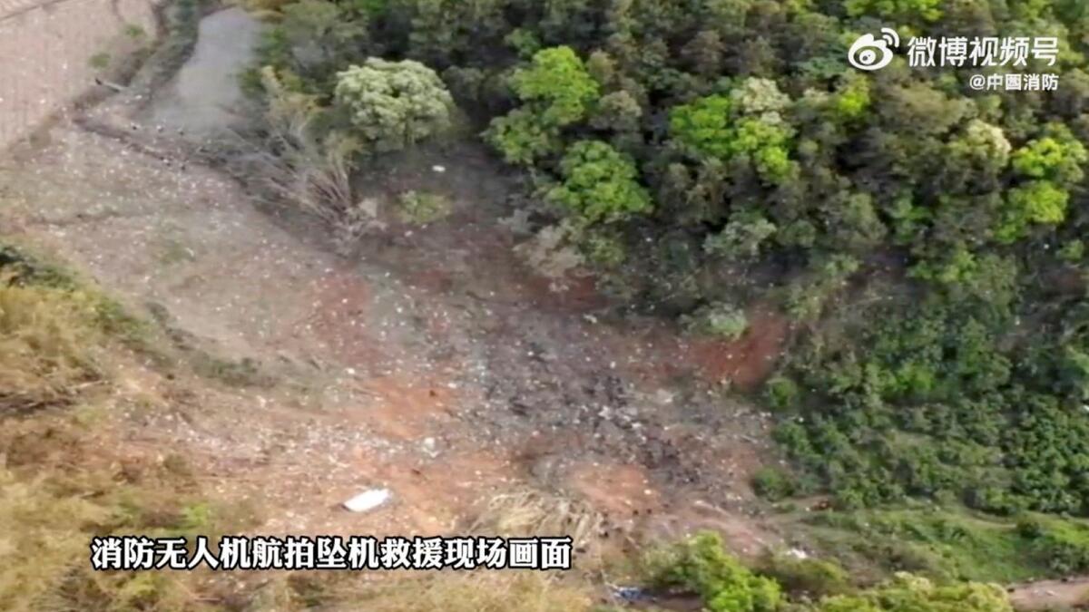 The general area of forest where the China Eastern Airlines Boeing 737-800 crashed in the Guangxi Region, China is seen in the screengrab from a video released on  March 21, 2022. Photo: Reuters