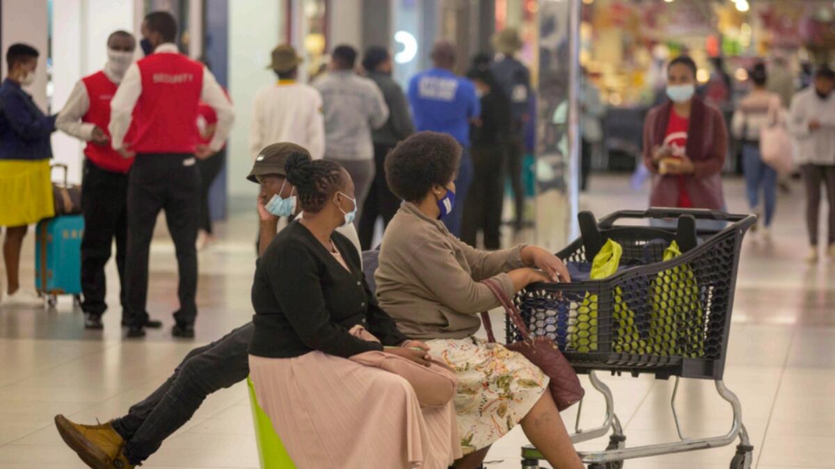 People shop in a mall, in Johannesburg, South Africa. — AP