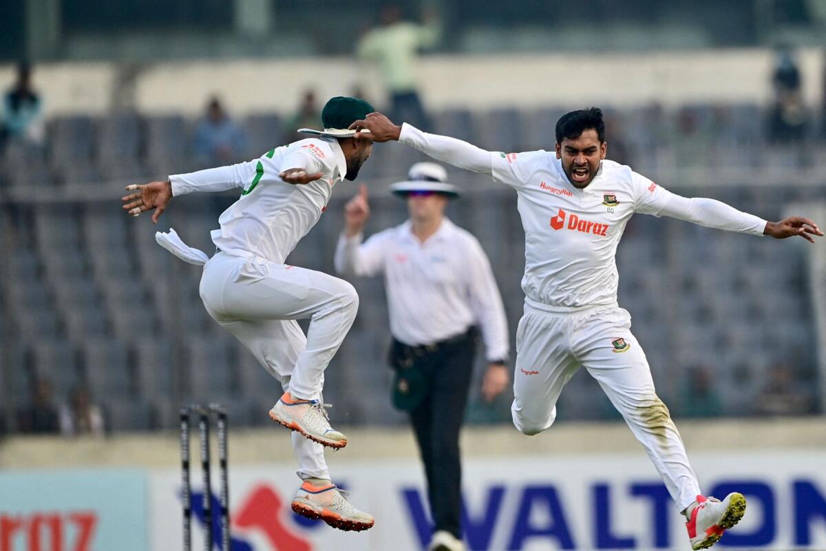 Bangladesh's Mehidy Hasan (right) celebrates after the dismissal of India's Virat Kohli during the third day of the second Test. (AFP)