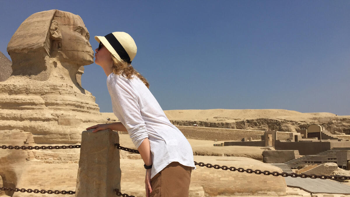Bonnell poses so that she appears to be kissing the Sphinx, which stands in the background, in Giza, Egypt.