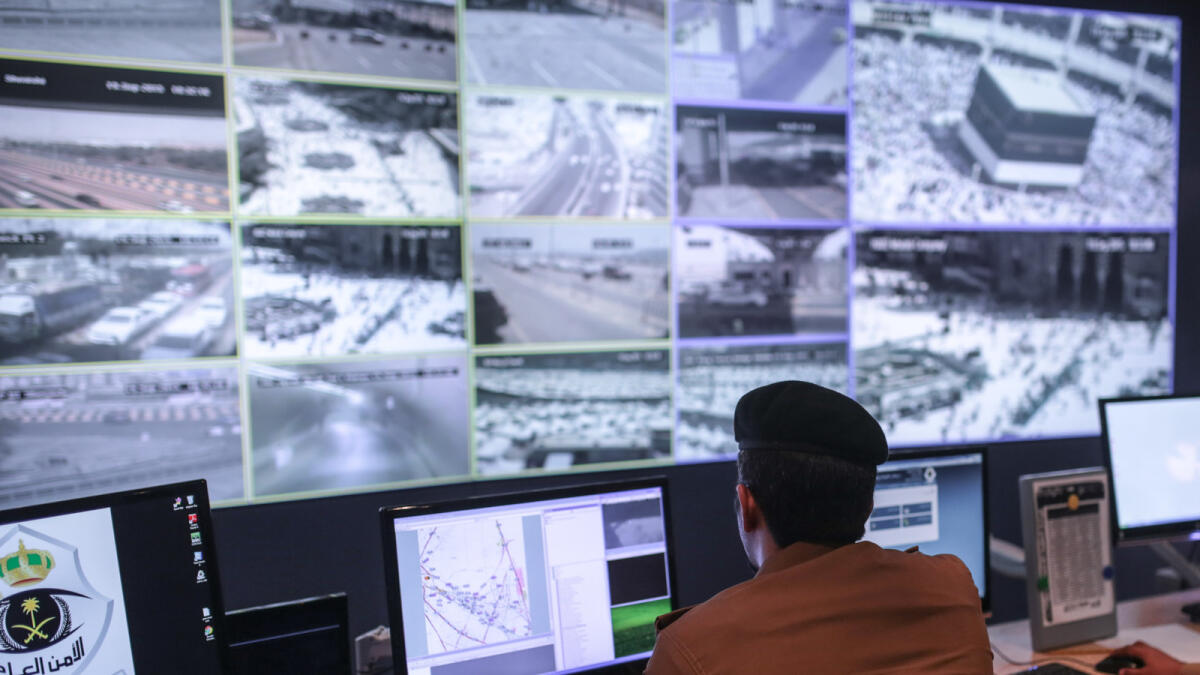 A Saudi security officer monitors screens with live views of Muslim pilgrims in the holy city of Mecca, along with highways and high density areas, a few days before the start of the annual pilgrimage, known as the hajj, in Mecca, Saudi Arabia, Saturday, Sept. 19, 2015. (AP Photo/Mosa'ab Elshamy)