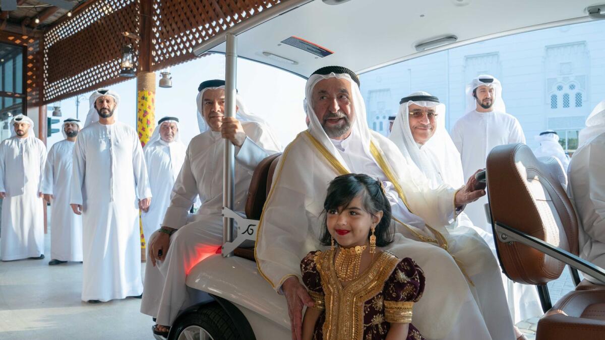 Sheikh Sultan greets a girl during his tour of Kalba Heritage Market.