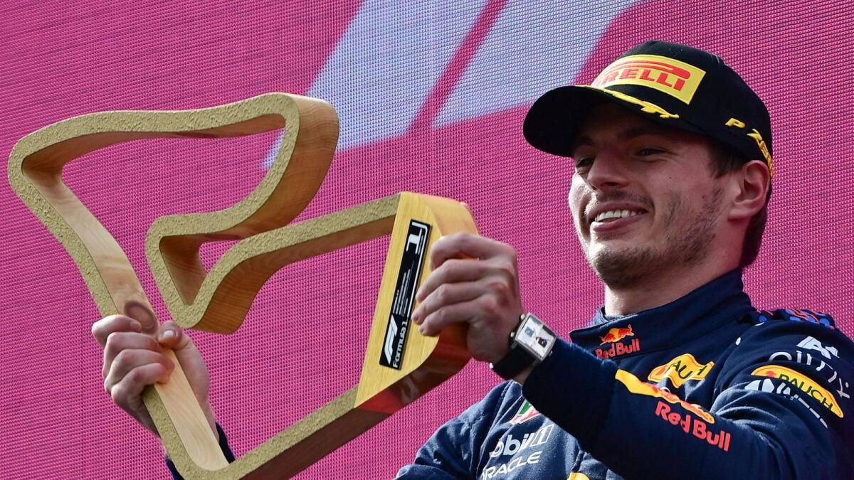 Red Bull's Dutch driver Max Verstappen celebrates with his trophy on the podium after winning the Formula One Austrian Grand Prix. — AFP