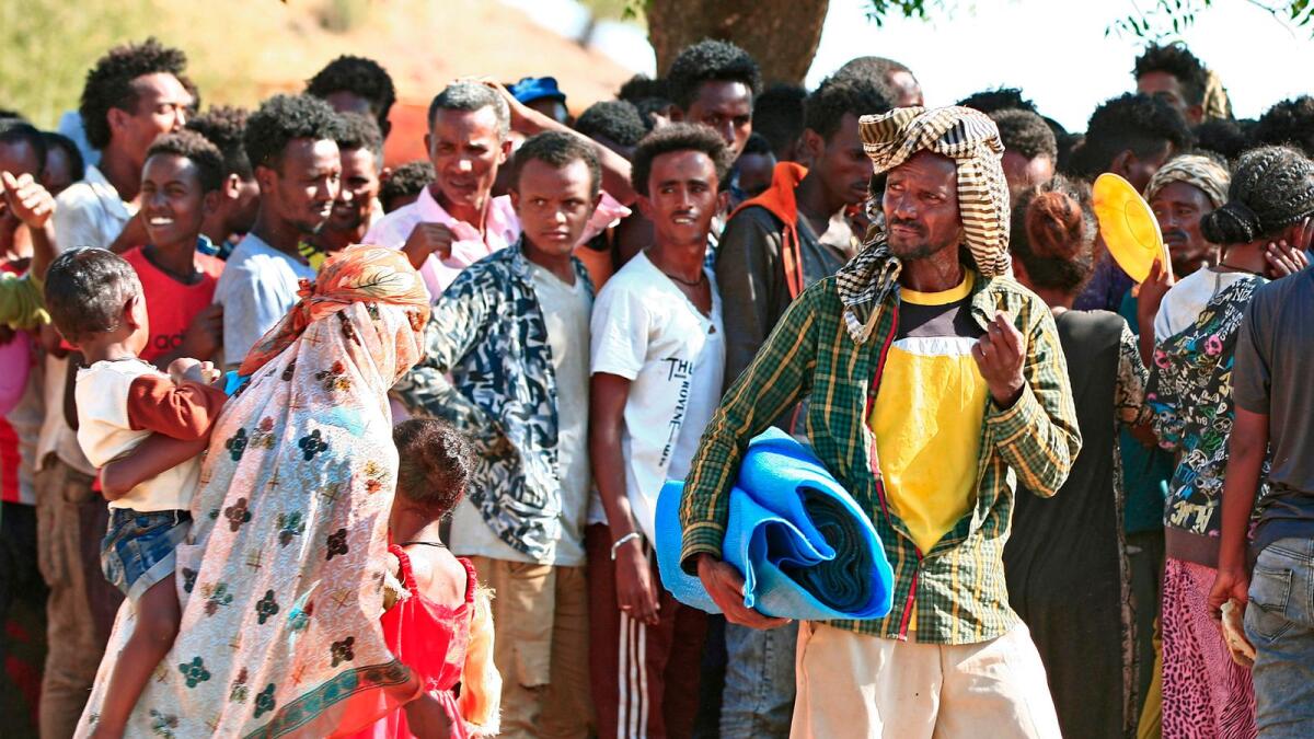 Ethiopian migrants, who fled intense fighting in their homeland, gather in the Um Raquba camp in the town of Gadaref, east of Khartoum after being transported from the border reception centre.