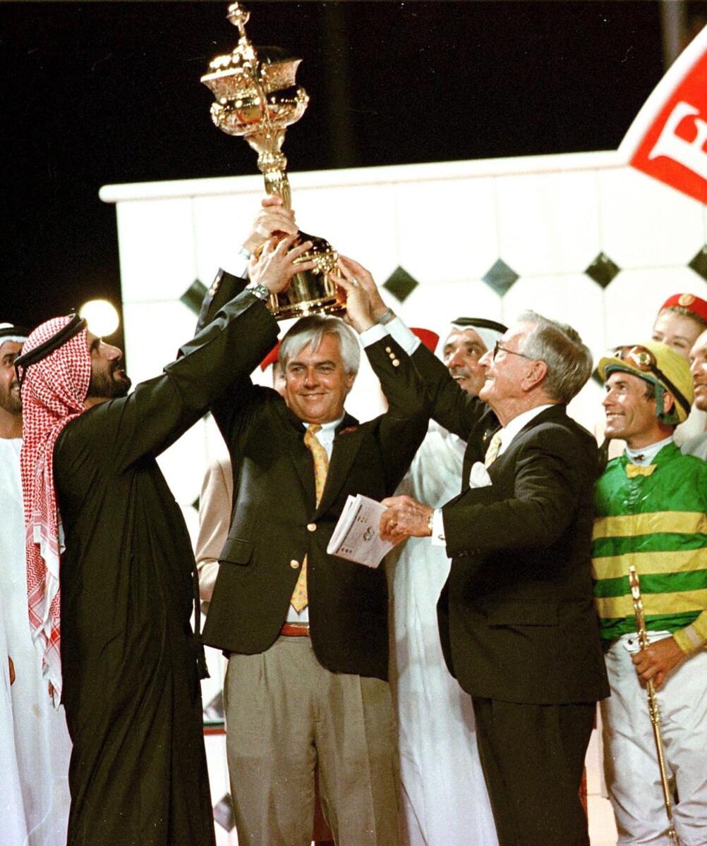 Sheikh Mohammed bin Rashid Al Maktoum presents the trophy to Bob Baffert after the trainer's horse Silver Charm won the 1998 Dubai World Cup. — AFP file