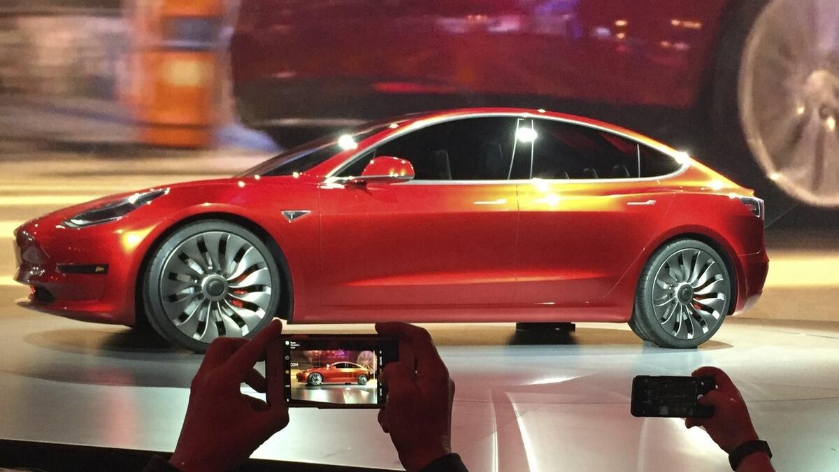Tesla delivers first Model 3 cars in historic moment