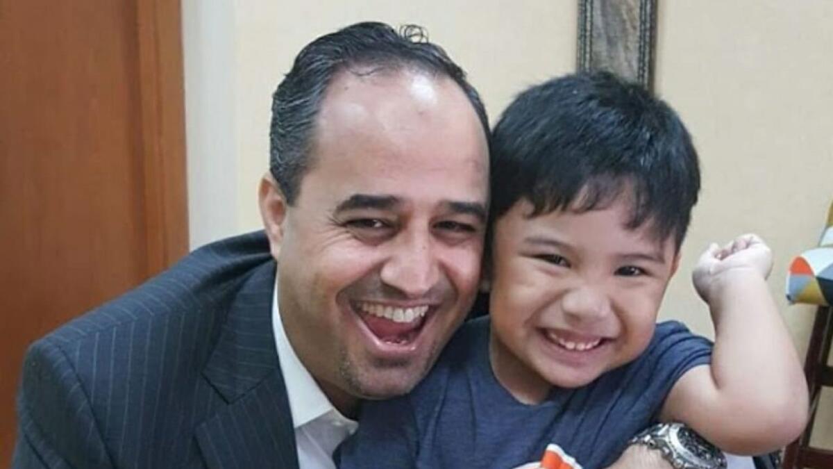 Dr Hamza Alsayouf with one of the children. Supplied photo