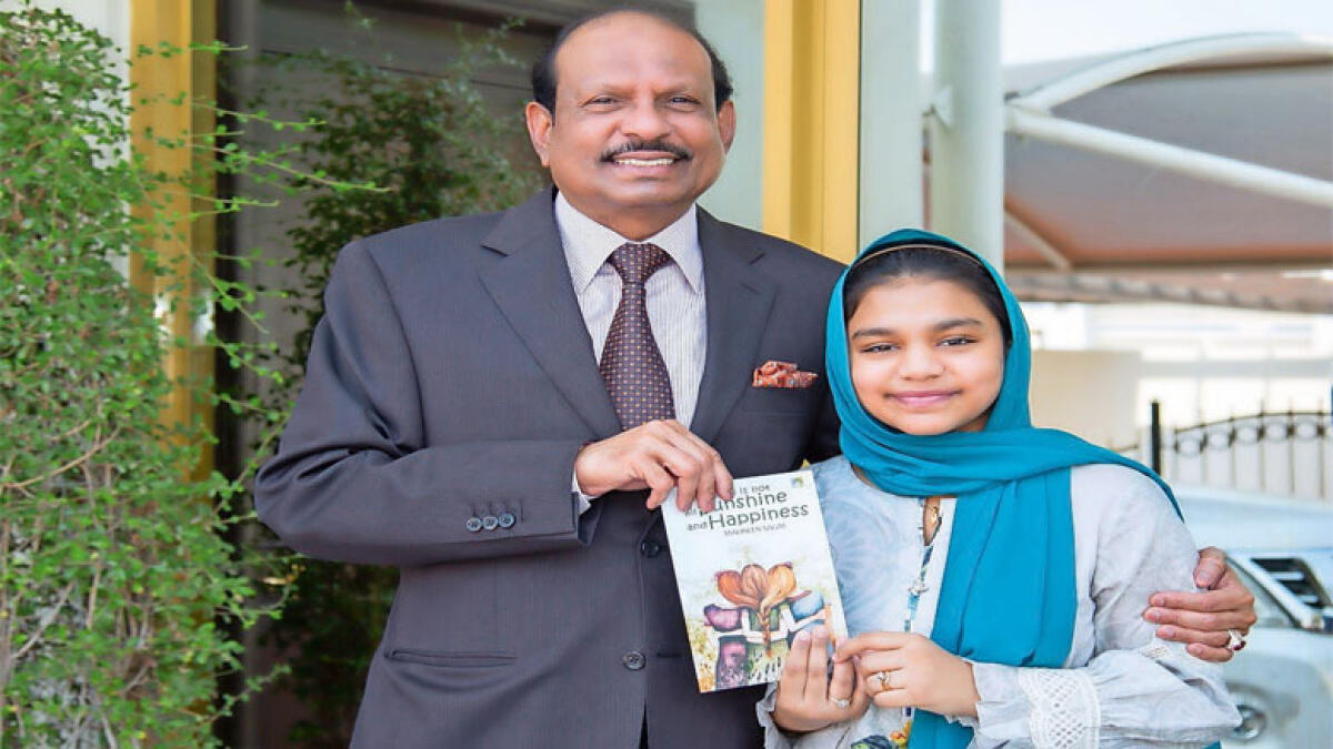 READ ALL ABOUT IT: Mehreen Salim, a ninth-grade Malayalee student, presents her first book, The World Is Not All Sunshine and Happiness, to LuLu Group chairman Yusufali MA. The young author showcased her work at the Sharjah International Book Fair.