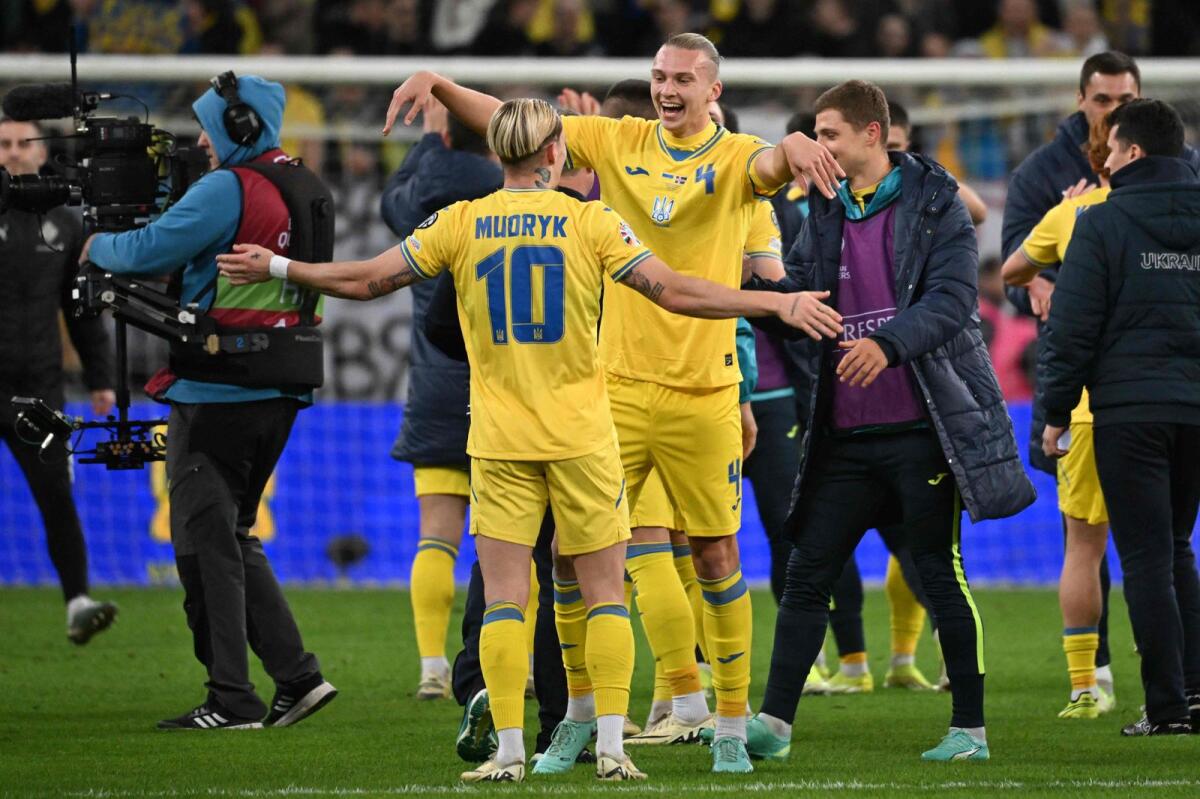Ukraine's Mykhaylo Mudryk and Maksym Talovierov celebrate the win. — AFP