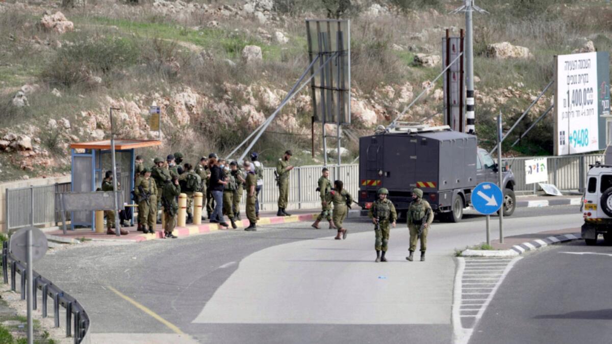 Israeli soldiers gather at the site of an attempted stabbing attack at a junction near the settlement of Giti Avishar in the West Bank. — AP
