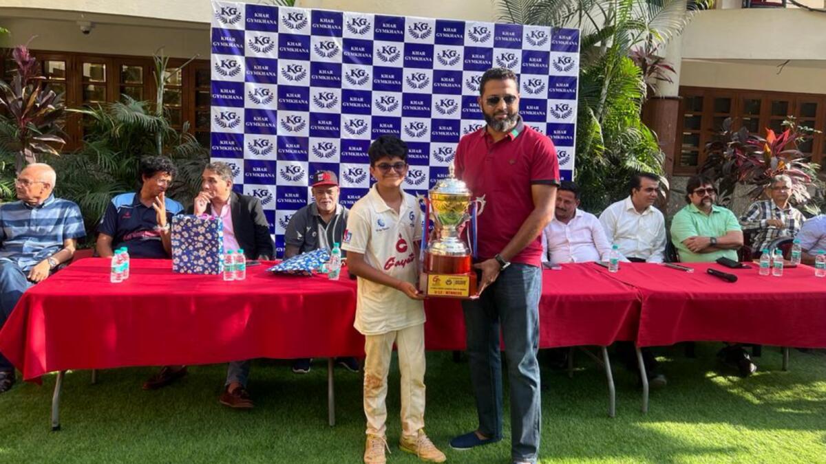 Former India batsman Wasim Jaffer presents a trophy to a G Force Academy player during the Dubai-based academy's India tour this year