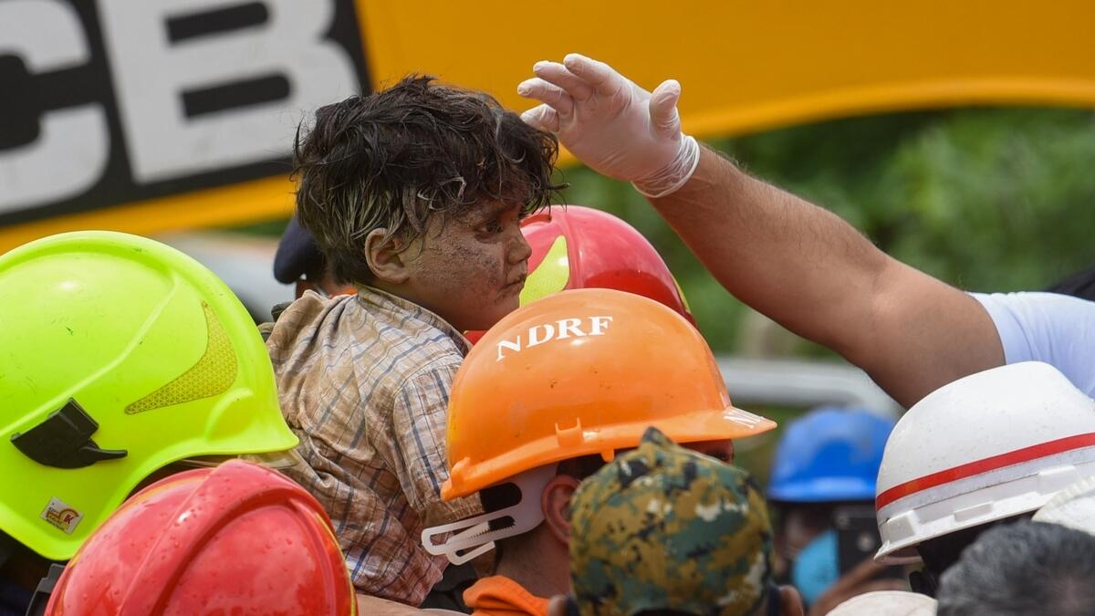 rescuers, four-year-old boy, rubble, collapsed, building, india, mahad