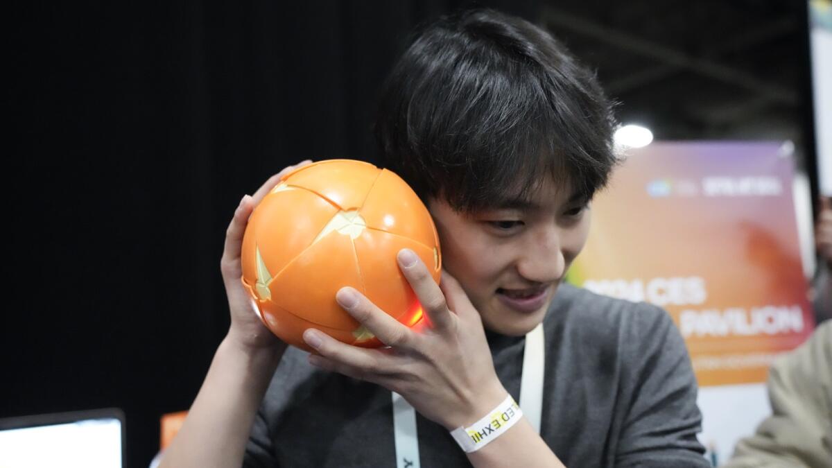 Juho Seo, of Solive Ventures, demonstrates using the Peel &amp; Play educational sensory toy, designed to help children with self-stimulatory behaviour. — AP