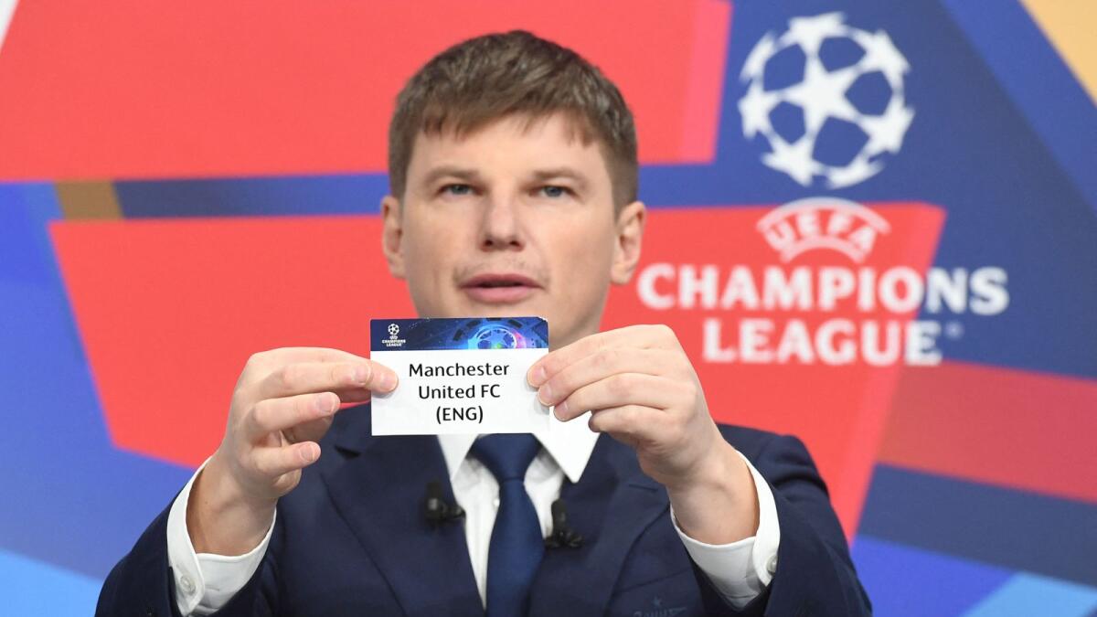 Former Russian international forward Andrey Arshavin holds the name of Manchester United during the Champions League round of 16 draw at the Uefa headquarters in Nyon on Monday. — AFP