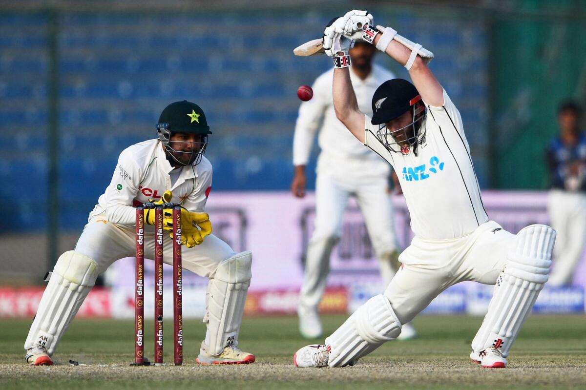 New Zealand's Kane Williamson (right) leaves the ball during the third day of the first Test at the National Stadium in Karachi. — AFP