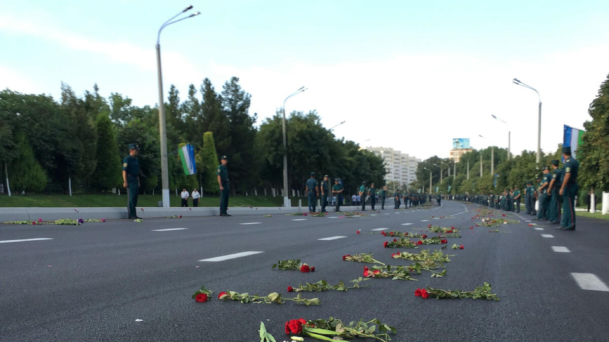 Flowers lie on a street after a hearse believed to be carrying the body of Uzbek President Islam Karimov passed through on the way to the airport in Tashkent on September 3, 2016. Uzbekistan will bury President Islam Karimov on September 3, as his death plunges the Central Asian nation into the greatest period of uncertainty in its post-Soviet history with no clear successor to the iron-fisted ruler. Karimov, 78, was pronounced dead late Friday after he suffered a stroke last weekend and fell into a coma, the authorities said, following days of speculation that officials were delaying making his death public. The funeral for the strongman -- who dominated the ex-Soviet nation for some 27 years -- will be held in his home city of Samarkand, central Uzbekistan, Saturday morning and the country will begin three days of mourning./ AFP