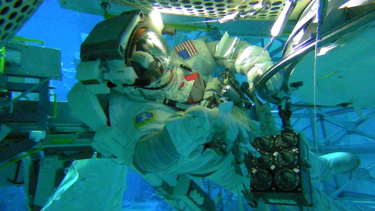 In the Neutral Buoyancy Lab at Johnson Space Centre, a Nasa astronaut tests collection methods for ISS External Microorganisms. Credit: Nasa