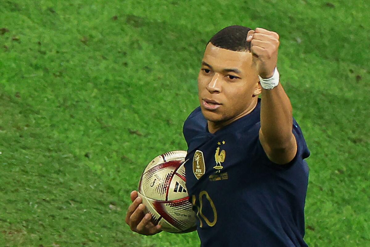 France's forward Kylian Mbappe celebrates scoring his team's first goal from the penalty spot during the 2022 World Cup final against Argentina. — AFP