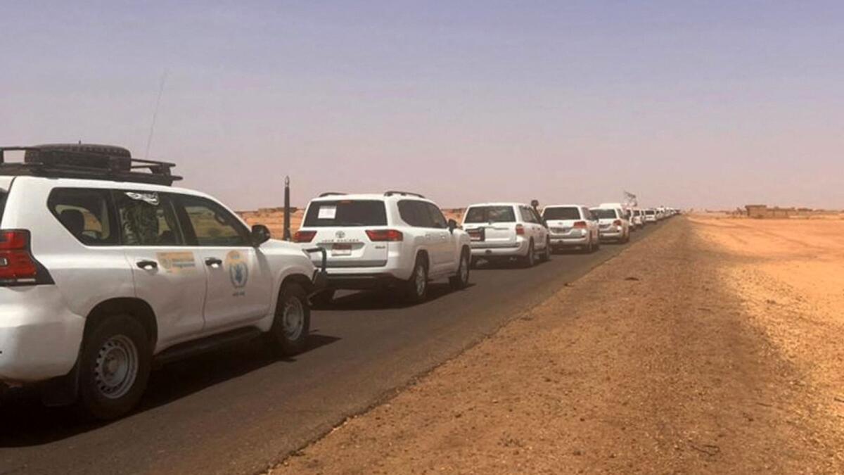 A convoy leaving Khartoum advances on a road towards Port Sudan. — AFP