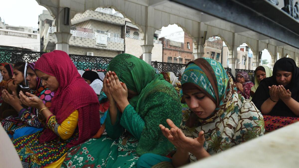 Muslim women offer prayers on the last congregational Friday prayers of the holy month of Ramadan, ahead of the Muslim festival of Eid Al Fitr, at the Data Darbar mosque in Lahore.