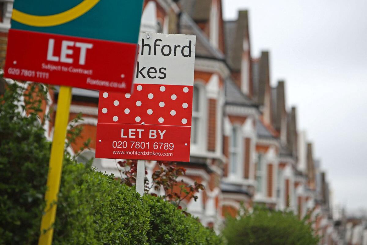 Estate agents rental boards advertising properties to let are pictured outside a row of Victorian terraced houses in Lavender Hill, in south London. -- AFP