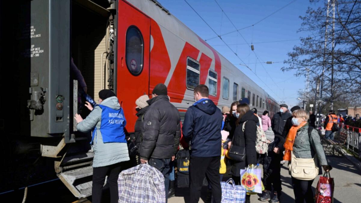 People from the Donetsk and Luhansk regions, the territory controlled by pro-Russia separatist governments in eastern Ukraine, get on a train to be taken to temporary residences in other regions of Russia. — AP