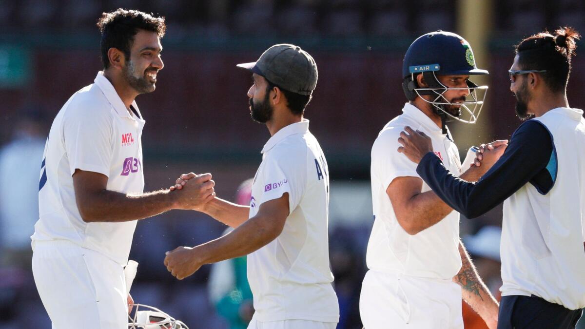India's Ravichandran Ashwin is congratulated by his captain Ajinkya Rahane as Hanuma Vihari is congratulated by teammate Mohammed Siraj following play on the final day of the third cricket test between. — AP