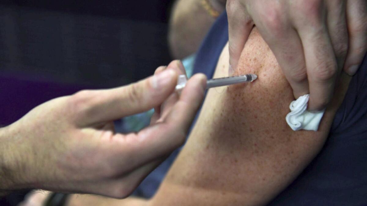 A nurse vaccines with Moderna Covid-19 vaccine in a vaccination centre in Garlan, France. — AFP