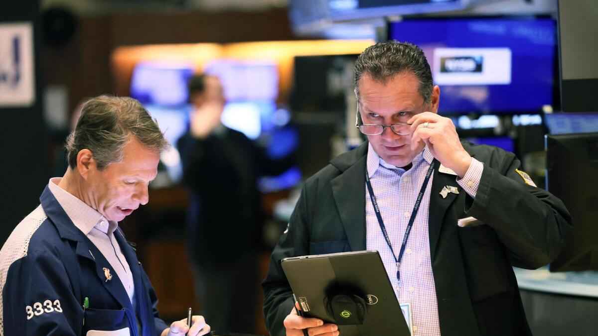Traders work on the floor of the New York Stock Exchange (NYSE) on Friday. sentiment in recent weeks reinforced the view among some investors that asset prices may be heading for a more benign period. - AFP