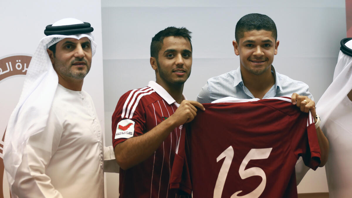 SP190715- (L-R) Dr. Jumaa Alhosani - Badr Al-Harthy, Al Wahda player and New player, Brazilian, Denilson Pereira Neves, during Received the club shirt of Badr No. 15- During press conference Al Wahda club To announce New player at Al Wahda club - Abu Dhabi - K. Photo By Nezar Balout