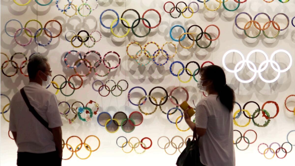 People look at the Olympic Rings at the Japanese Olympic Museum near the National Stadium in Tokyo. — Reuters