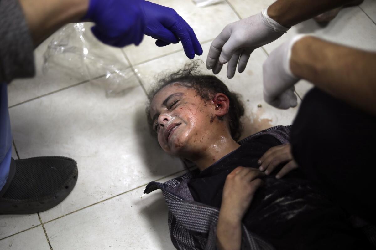 A Palestinian child wounded during the Israeli bombardment of the Gaza Strip receives treatment at the Nasser hospital in Khan Younis, Southern Gaza Strip, on  January 6, 2024. — AP