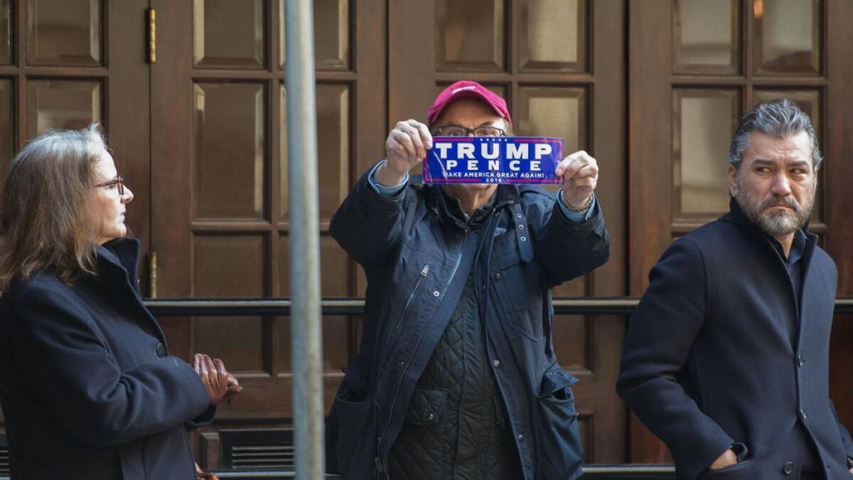 A man holding a Trump sticker