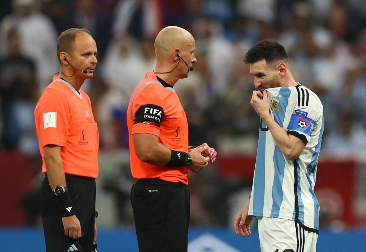 Argentina's Lionel Messi (right) with referee Szymon Marciniak during the World Cup final. (Reuters)