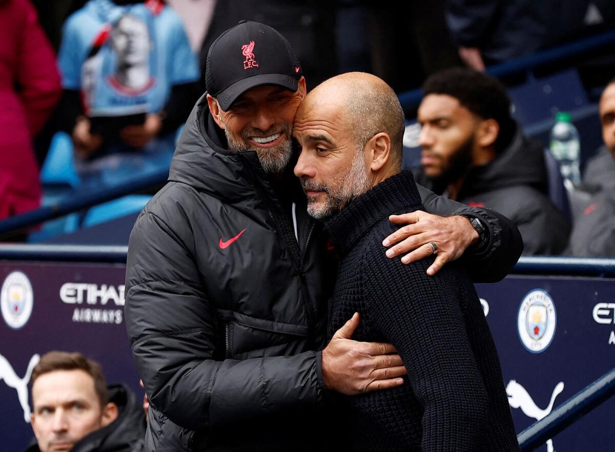 Manchester City manager Pep Guardiola (R) with Liverpool boss Juergen Klopp. - Reuters File