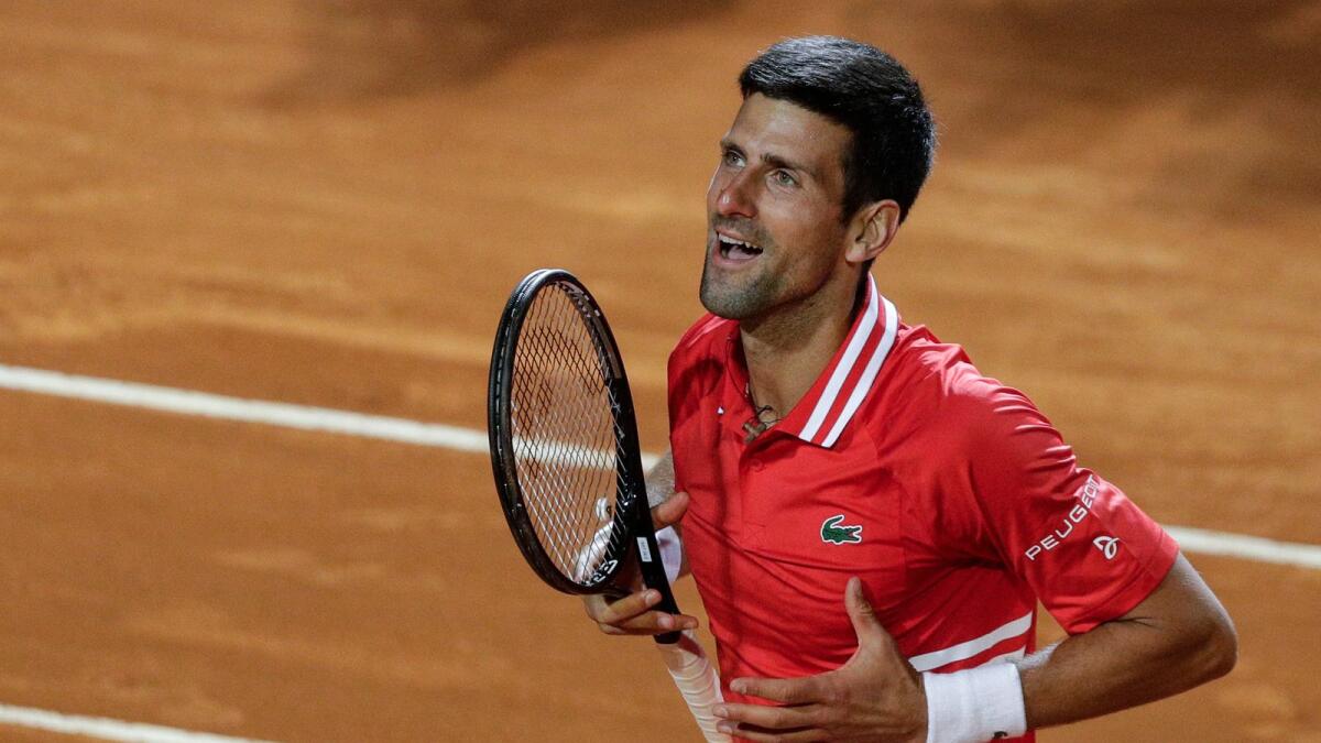 Serbia’s Novak Djokovic celebrates after beating Italy's Lorenzo Sonego in their semifinal. — AP